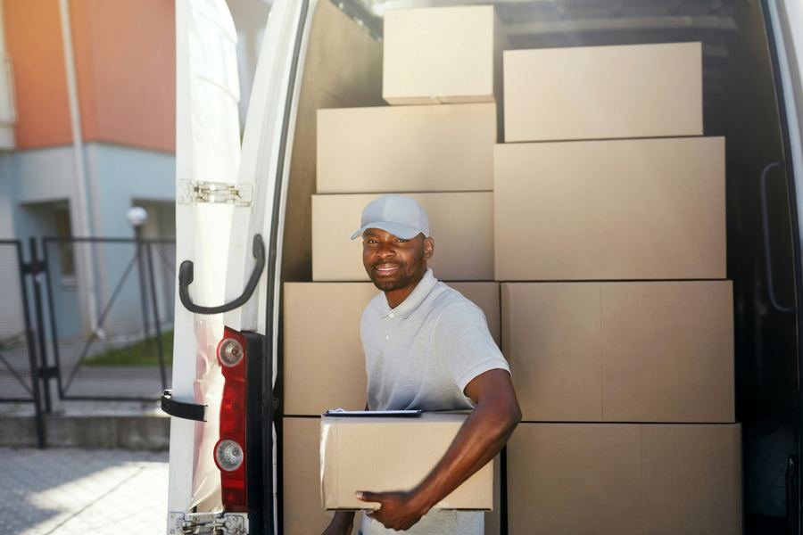 DAT International delivery team member loading a van